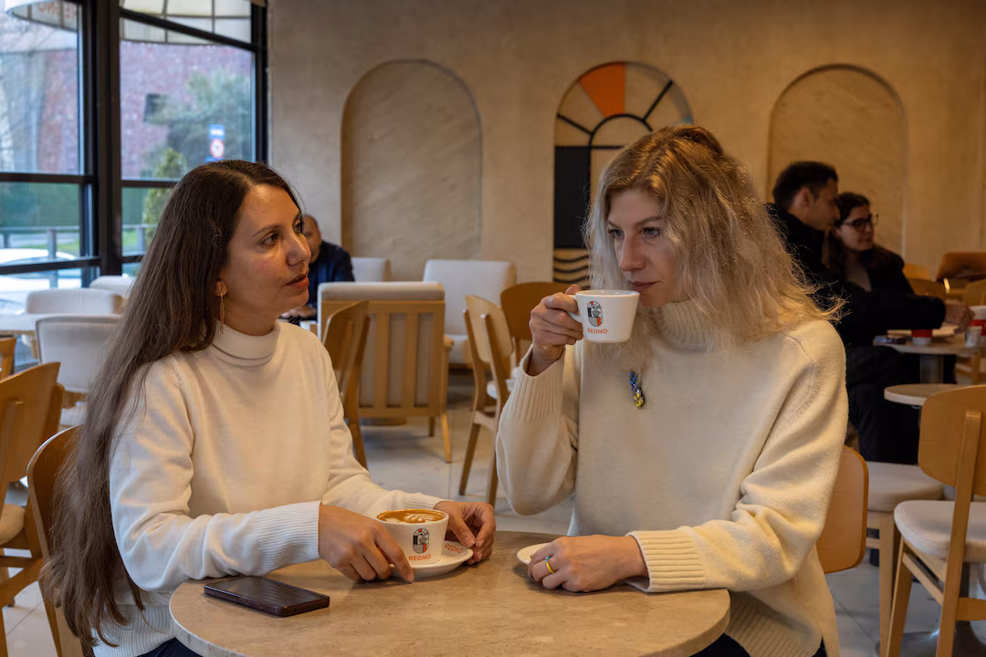 IIryna Kushnir and her high school friend Olga Yermolenko, Ukrainian women who fled Kharkiv after Russia launched a full-scale invasion, chat in a cafe in Istanbul