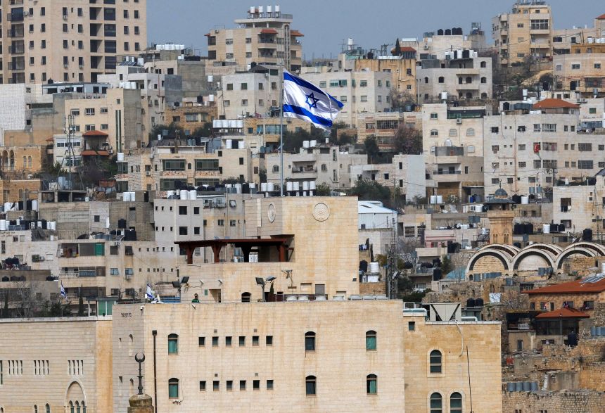 An Israeli flag flies over an Israeli settlement in the old city in Hebron in the occupied West Bank on February 9, 2026.